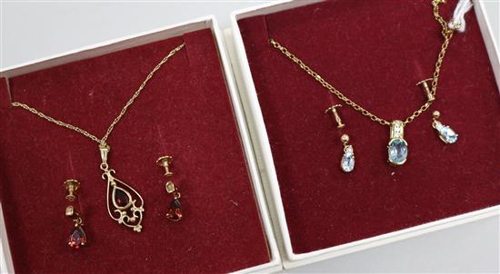A blue topaz and 9ct gold necklace and earrings en suite and a 9ct gold and garnet openwork pendant and earrings en suite